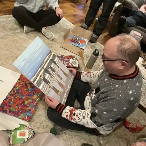 Photo of man receiving completed custom paint by numbers kit as a gift